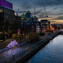 Cinematic Sky Drone shot from above at night of sculpture beside the river Liffey
