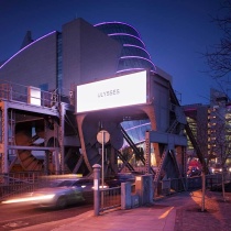 cars passing through docklands sculpture