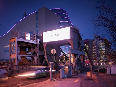 cars passing through docklands sculpture