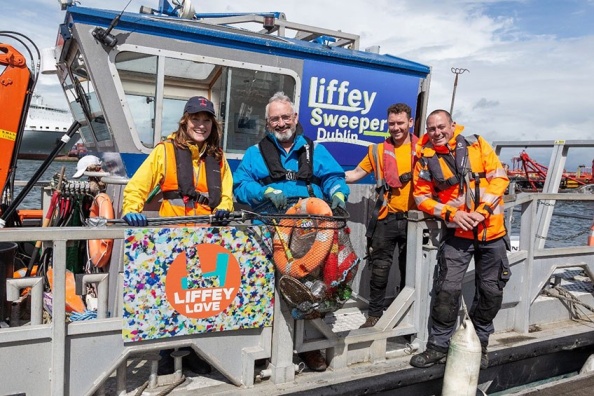 Artist Rhona Byrne with Liffey Sweep boat crew on the Liffey Sweep boat